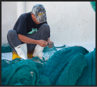 Worker weaving sustainable fish net