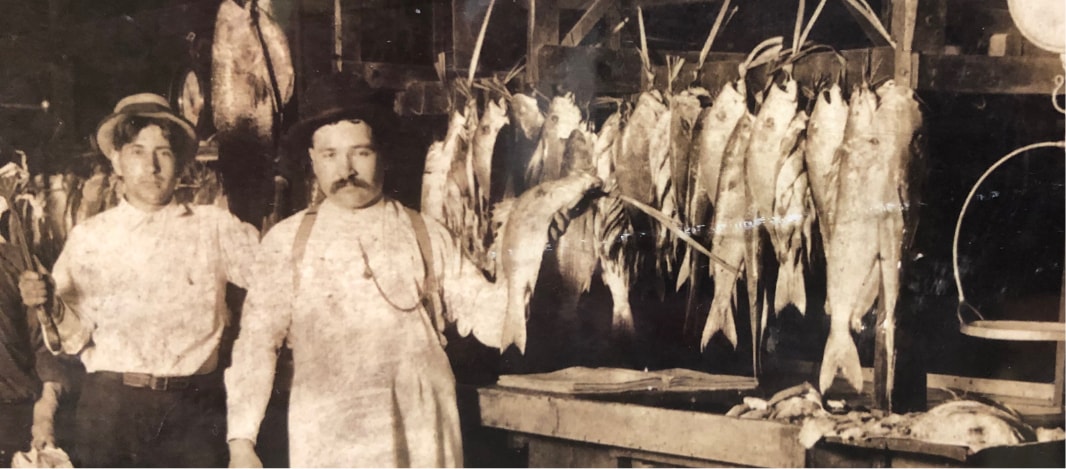 Paul Piazza standing with rabbit and fish