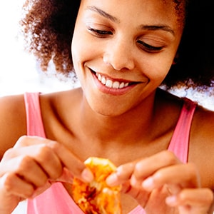 Woman eating shrimp for its many nutritional benefits